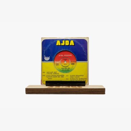 Vintage Ajda music vinyl cover with blue and yellow design displayed on a wooden pedestal.