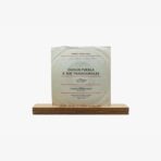 2301450038B | 3345 Records Vinyl record sleeve titled 'Carlos Puebla e Sus Tradicionales' resting on a wooden display base on a white background (antique album).