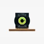 2301450038C | 3345 Records Black vinyl record resting on a wooden display base with a black square backing, set against a white background.