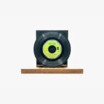 2301450038D | 3345 Records Black vinyl record mounted on a wooden pedestal against a white background, with a bright yellow-green center label.