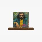 2301450049B | 3345 Records Vintage vinyl album cover for Cem Karaca featuring a man with dark glasses, beard, and long hair in a yellow turtleneck and teal jacket, pink 'Cem Karaca' text, on a wooden stand.