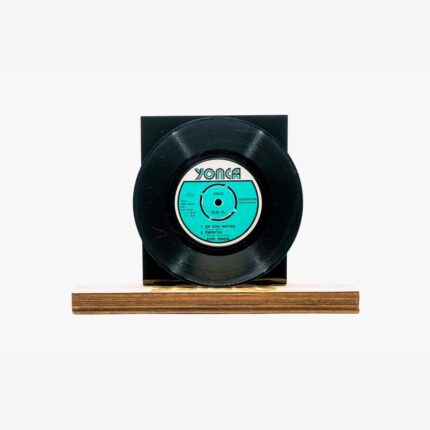 Vintage black vinyl record mounted on a wooden display base with a turquoise label at center label reads Yonca (classic record).